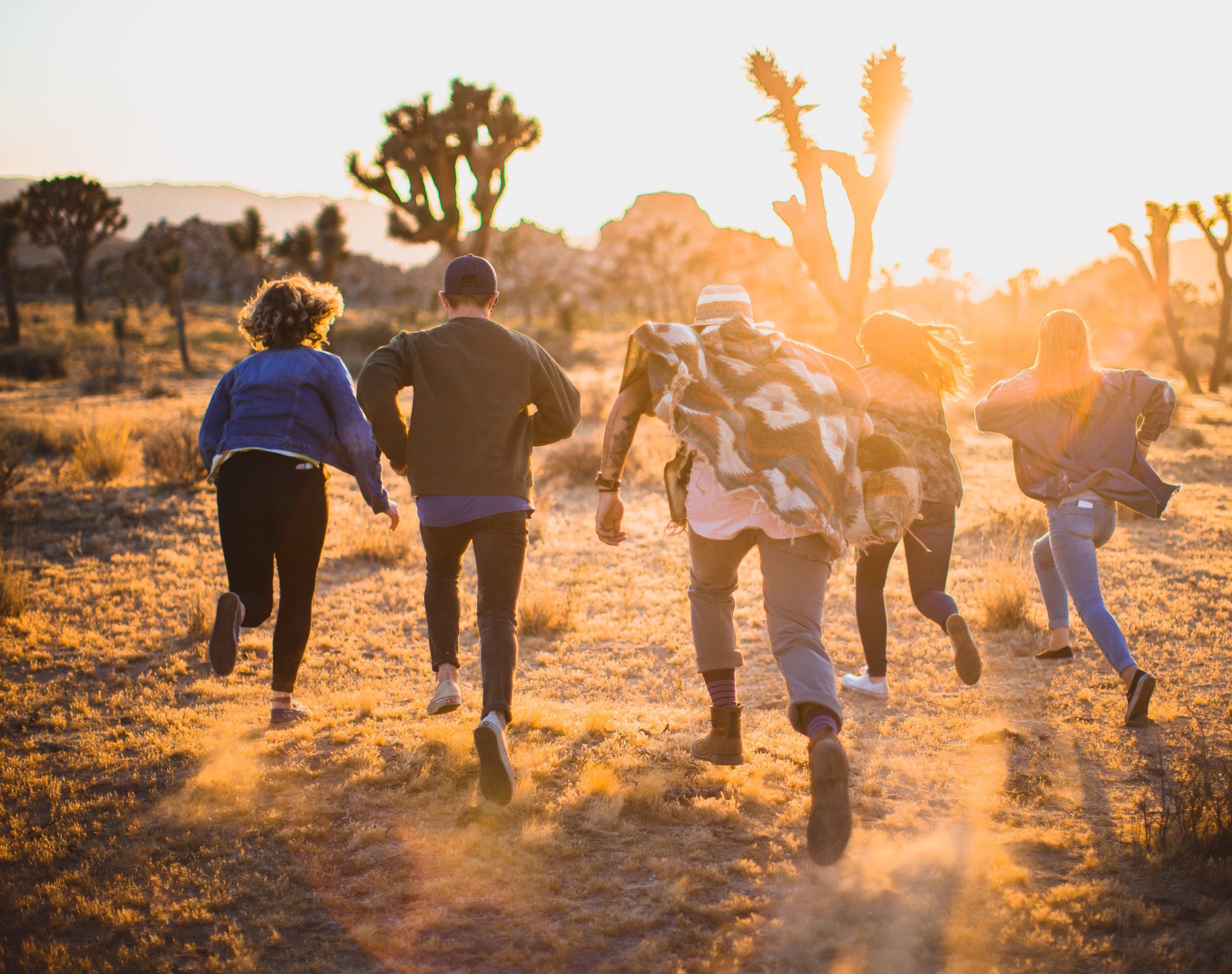 photo showing young people running towards the sun