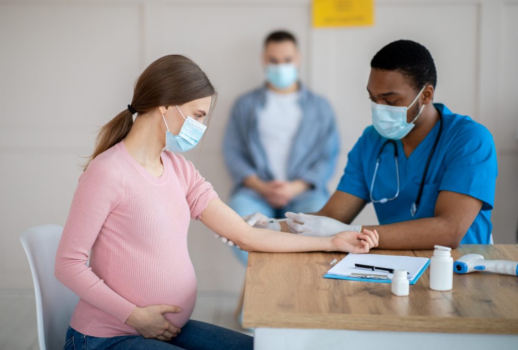 Pregnant Person getting vaccinated